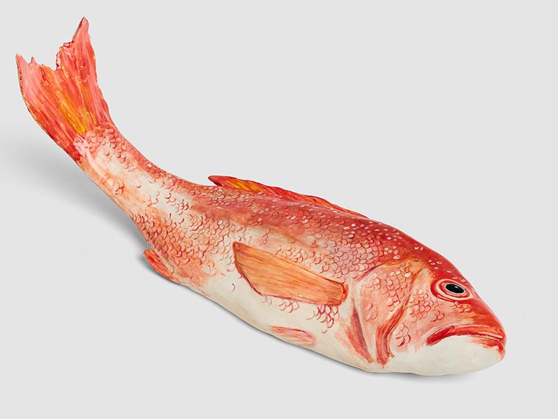 A ceramic fish, painting in orange hues